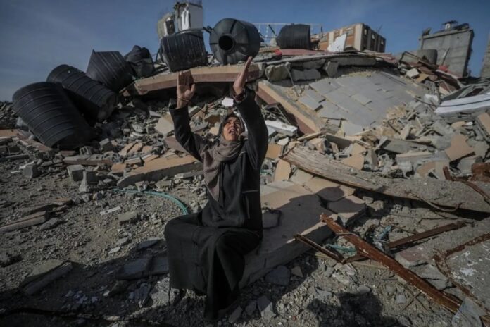 Gazans wade through the rubble to return home after the ceasefire.

